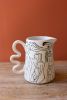 ABSTRACT FIGURE PITCHER WITH SQUIGGLE HANDLE