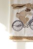 TEA TOWEL - EASTER RABBIT ON A BIKE